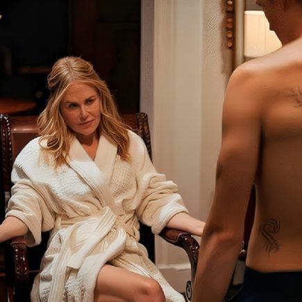 Vampire and older woman embracing under moonlight in gothic setting