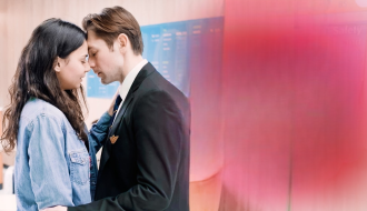 Pilot comforting refugee girl inside airport terminal in emotional love story