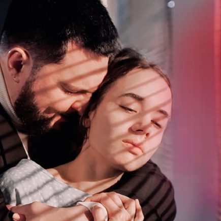 Millionaire Henry Carter holding Emily’s hand in a romantic candlelit hospital room during an emotional love story about sacrifice, cancer, redemption, and true love.